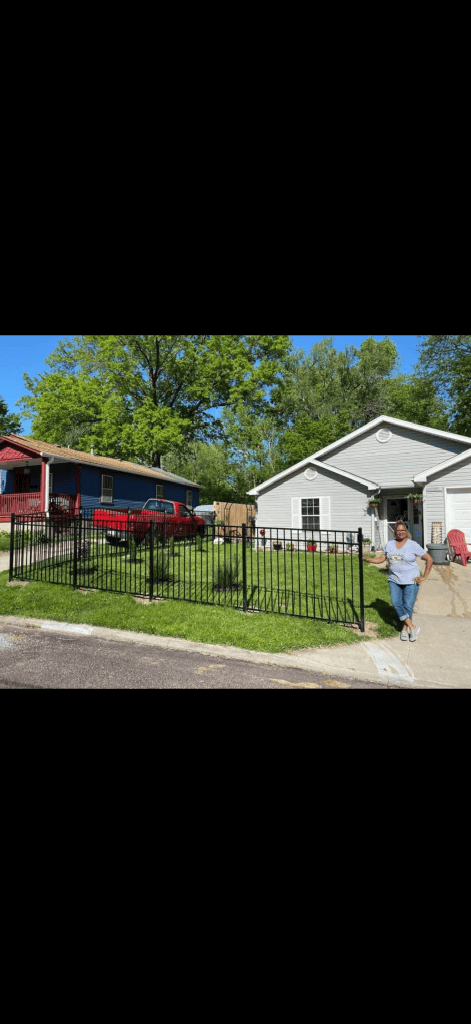 Black aluminum estate fence along a front yard