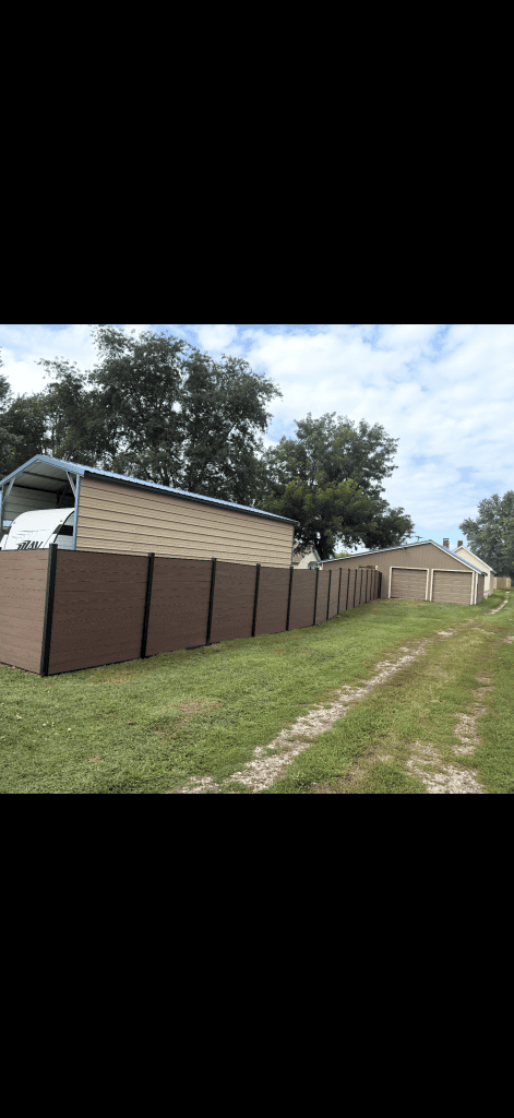 Brown horizontal privacy panels and dark posts along a grass side yard.