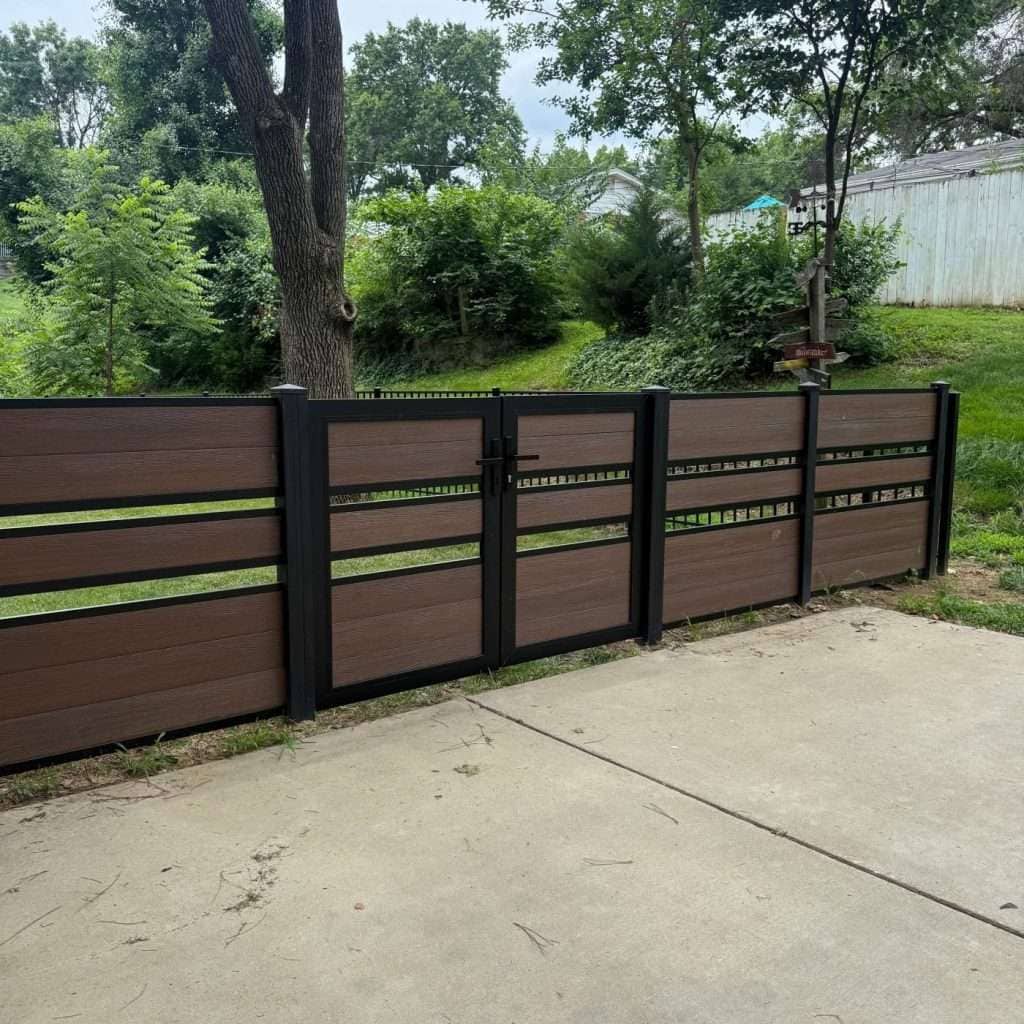 Brown horizontal fence and gate with narrow gaps along a concrete patio.