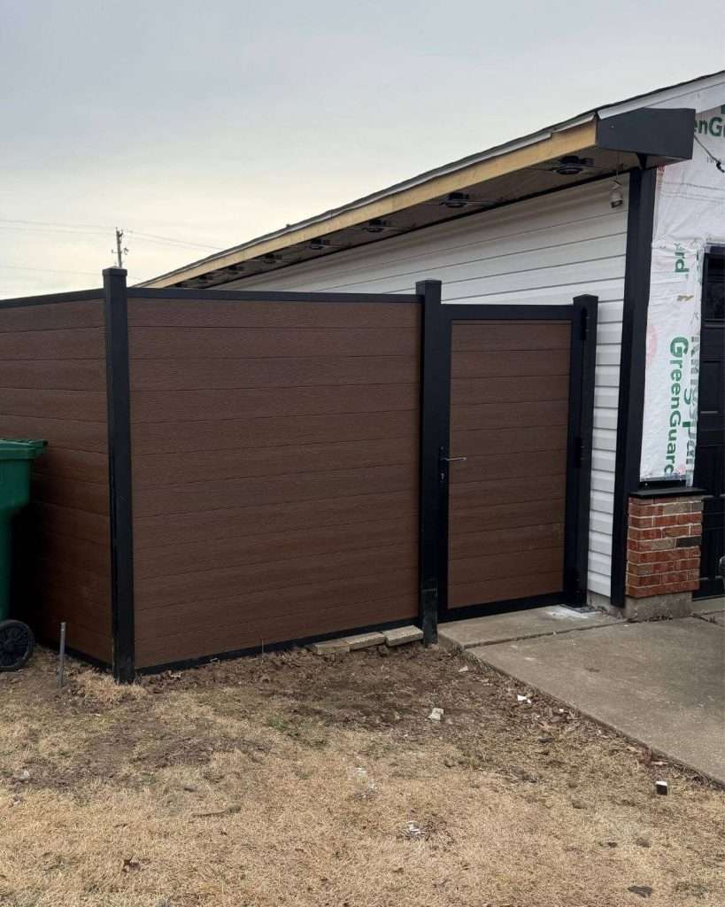Brown privacy fence and walk gate beside a garage entrance.
