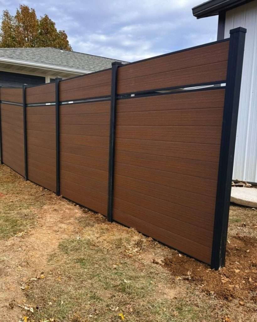 Brown horizontal fence with an open accent band beside a light-colored building.