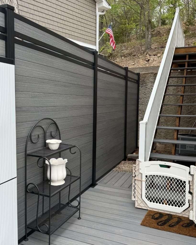 Gray horizontal privacy screen beside a deck and outdoor stairs.